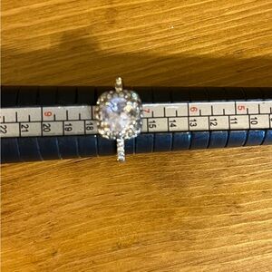 Cubic zirconia silver tone ring held in with 4 prongs halo setting size 7 1/2